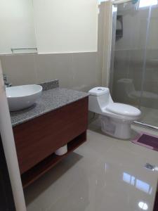 a bathroom with a sink and a toilet at Turqueza Home in Esmeraldas