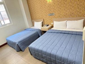 Postel nebo postele na pokoji v ubytování Songshan Hotel
