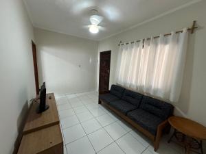 a living room with a couch and a table at Canto do Forte in Praia Grande