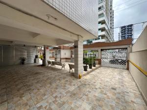 an outdoor patio with two benches on a building at Canto do Forte in Praia Grande