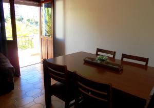 a dining room table and chairs with a table and a door at Casa Ameijeira in Lagos