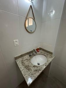 a bathroom with a sink and a mirror at Canto do Forte in Praia Grande +23 photos