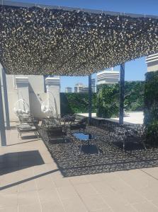 a group of chairs under a pavilion with a table at Monoambiente con amenities Y MAS in Buenos Aires