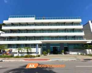 a large white building with a lot of windows at AX Blue Suítes in João Pessoa