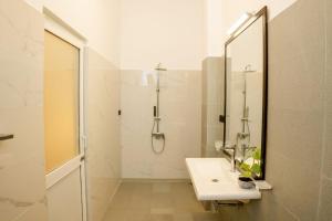 a white bathroom with a sink and a shower at AGP Greeny View Resident in Galle