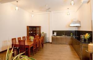 a kitchen and dining room with a wooden table and chairs at AGP Greeny View Resident in Galle