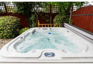 a jacuzzi tub in a backyard at Nature's Serenade:3BR Classic Home-Jacuzzi & Sauna in Canvey Island