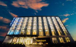 a building with a lit up facade at night at Copenhagen Residences - Ormoc in Ormoc