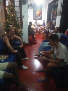 a group of people sitting around a christmas tree at CEYLON STAYZ in Colombo