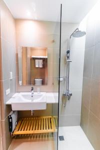 a bathroom with a sink and a shower at Copenhagen Residences - Ormoc in Ormoc