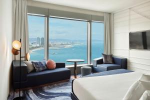 a hotel room with a bed and a view of the ocean at W Barcelona in Barcelona