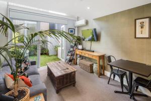 a living room with a couch and a table at Canvas Apartment in Wellington