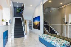 a hallway with a staircase and a couch in a room at The Abbott Boutique Hotel in Cairns