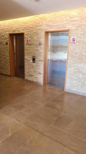 an empty room with two doors and a tile floor at Departamento Avenida Las Rastras Talca in Talca