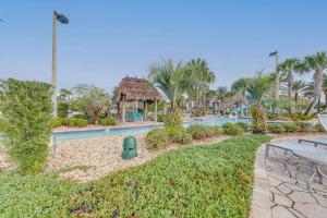 a resort with a swimming pool and palm trees at Disney/Epcot/Reunion Golf Course in Kissimmee