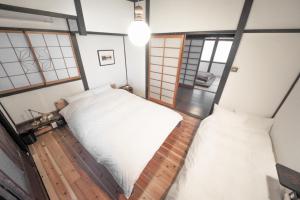Ліжко або ліжка в номері YADOSU Arts and Stay