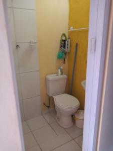 a small bathroom with a toilet and a shower at Casa da Ruthemar-Suite para 2 pessoas in São Sebastião