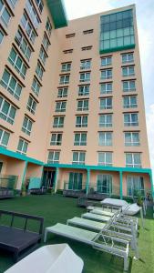 a large building with tables and chairs in front of it at Amerin Hotel Johor Bahru in Johor Bahru