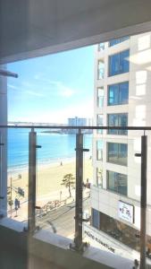 a view of a beach from a building with a window at 1 second to Gwanganbeach in Busan
