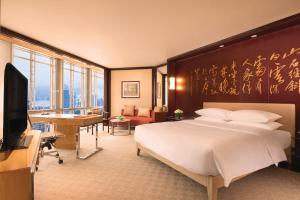 a bedroom with a large bed and a living room at Grand Hyatt Shanghai in Shanghai