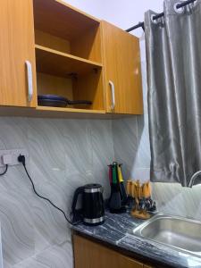 a kitchen counter with a coffee maker and a sink at Beautiful single room studio apartment in Ilasan lekki magnanimous in Lekki