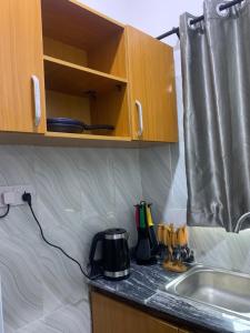 a kitchen counter with a coffee maker and a sink at Beautiful single room studio apartment in Ilasan lekki magnanimous in Lekki +3 photos
