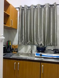 a kitchen counter with a sink and a window at Beautiful single room studio apartment in Ilasan lekki magnanimous in Lekki
