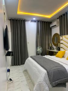 a bedroom with a large bed and a television at Beautiful single room studio apartment in Ilasan lekki magnanimous in Lekki
