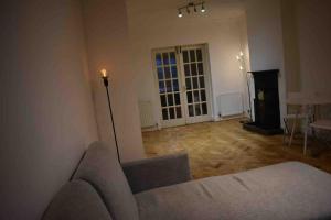 a living room with a couch and a table at Lovely 3 Bedroom House South Norwood London in Norwood