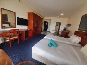 a hotel room with a bed with a blue object on it at Rainbow Paradise Homestay @ Tanjung Bungah by Landmark in Tanjung Bungah