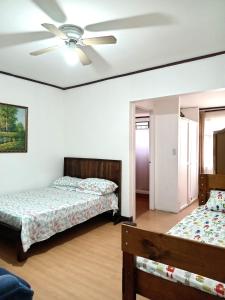 1 Schlafzimmer mit 2 Betten und einem Deckenventilator in der Unterkunft Chavenogue Hotel in San Juan