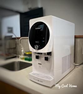 a white coffee maker sitting on a counter next to a sink at My Cool Home x The Quintet @ Cameron Highlands in Tanah Rata