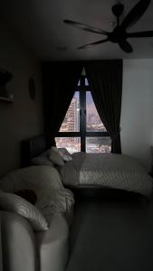 ein Schlafzimmer mit einem Bett und einem großen Fenster in der Unterkunft Ampang Neu Suites by DreamOak in Kuala Lumpur