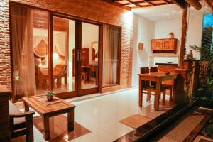 a living room with a table and a dining room at Way Ubud House in Ubud