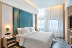 Postel nebo postele na pokoji v ubytování VIVERE Hotel, ARTOTEL Curated