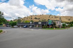 an empty street in a small town with a hill at Gundagai Motel in Gundagai