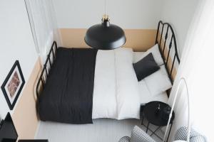 Postel nebo postele na pokoji v ubytování Miyako Shinjuku Hotel 都-新宿-