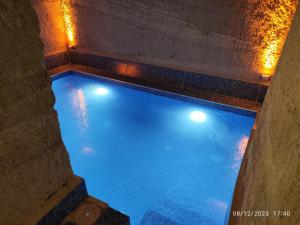 an overhead view of a swimming pool with lights at My Cave Suites in Nevsehir