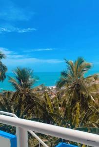 a view from the balcony of a resort with palm trees at Casa alto da Boa Vista in Maragogi