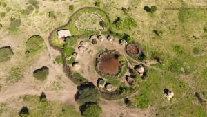 an aerial view of a building in the grass at DUPOTO HOMESTAY VILLAGE - MASAI VILLAGE (BOMA) in Mto wa Mbu