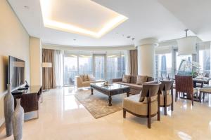 a living room with a couch and a table at EMAAR Residences Fashion Avenue - former Address Dubai Mall Residences by Qstay- Full Burj Khalfa Fountain view in Dubai