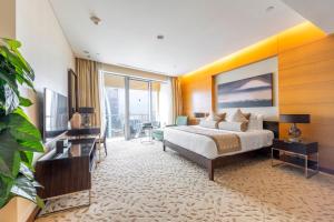 a hotel room with a bed and a television at EMAAR Residences Fashion Avenue - former Address Dubai Mall Residences by Qstay- Full Burj Khalfa Fountain view in Dubai