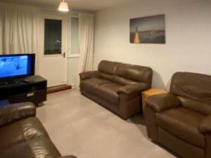 a living room with a couch and a flat screen tv at Normanton in Birmingham