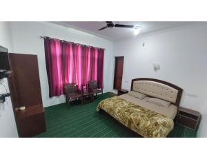 a bedroom with a bed and a pink window at HOTEL EVERGREEN SUNSHINE, Srinagar in Srinagar