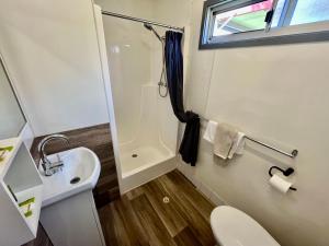 a small bathroom with a sink and a toilet at Young Caravan and Tourist Park in Young