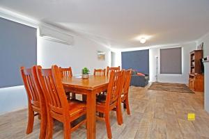 a dining room with a wooden table and chairs at Fishface Retreat in Jurien Bay