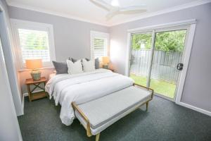 a white bedroom with a large bed and a window at Sundown Country Club in Bright