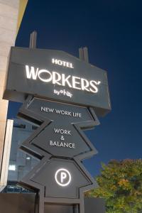 a sign for a hotel workers sign with arrows at Workers Hotel Daejeon by Aank in Daejeon