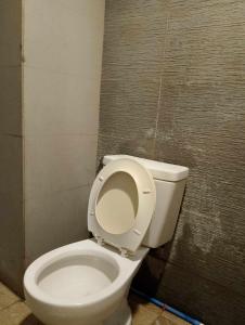 a bathroom with a white toilet in a stall at WJV INN PALAWAN in Puerto Princesa City