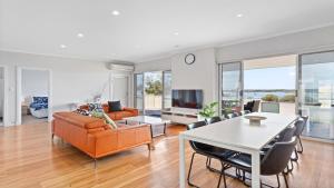 a living room with a couch and a table at Beachview in Coffin Bay